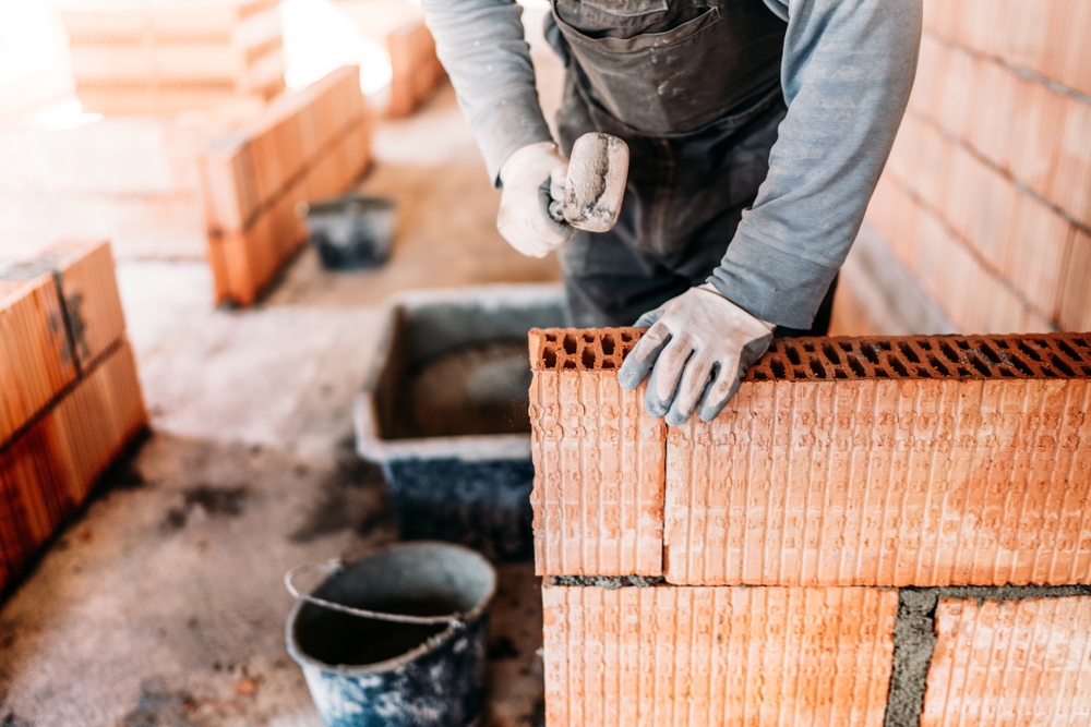 Industrial,Worker,,Bricklayer,And,Mason,Working,With,Bricks,And,Building