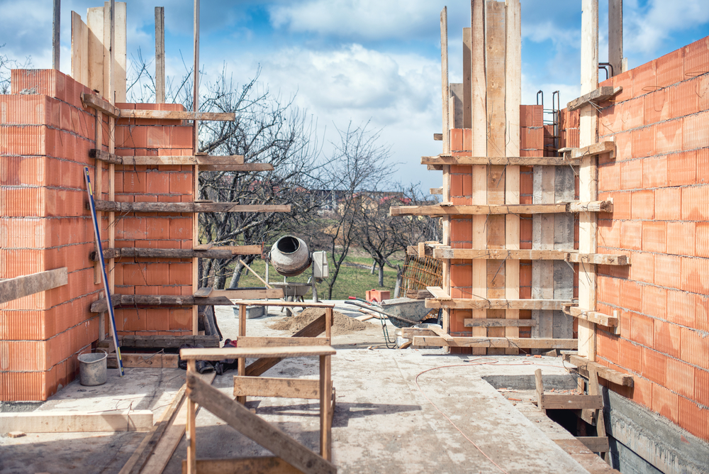 Construction,Site,,Tools,,Wheel,Barrow,,Sand,And,Bricks,At,New